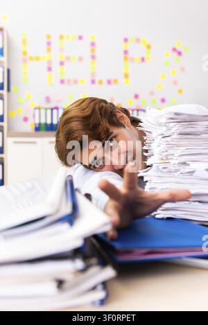 Young employee suffering from excessive work Stock Photo