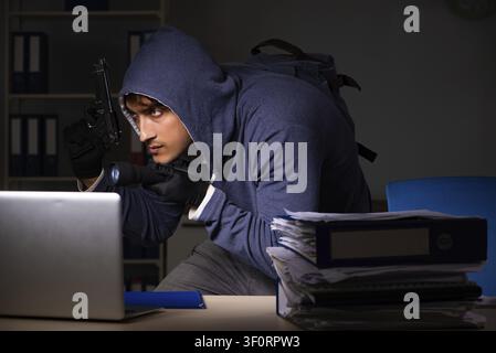 Thief trying to steal personal data in identity theft concept Stock Photo