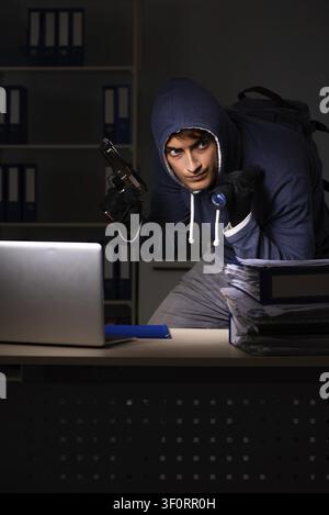 Thief trying to steal personal data in identity theft concept Stock Photo