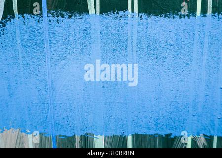 Old wall background with blue painted line over stripped green and white wall background Stock Photo