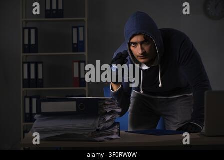 Thief trying to steal personal data in identity theft concept Stock Photo