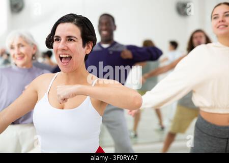 Group of dancing people practicing energetic swing Stock Photo