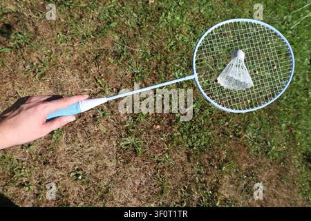 Hand Holding Badminton Racket And Shuttlecock Stock Photo