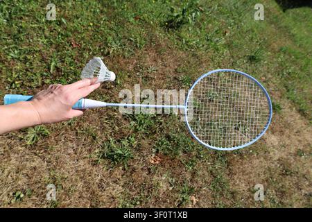 Hand Holding Badminton Racket And Shuttlecock Stock Photo