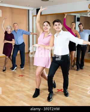 Young couple practicing passionate samba in dance class Stock Photo