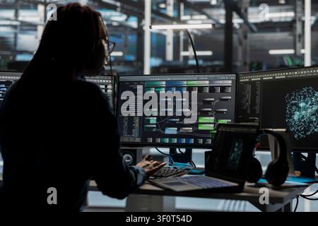 Server room software developer reviews AI visual analytics dashboard to pinpoint equipment performance problems. Stock Photo