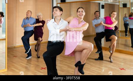 Young pair practicing Latino dance in dance studio Stock Photo