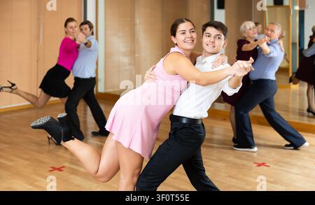 Young pair practicing ballroom dance in dance studio Stock Photo