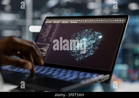 Server room technician working with laptop, running AI prediction simulations, tracking performance. Stock Photo