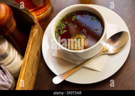 Bowl of beef soup with liver dumpling on table Stock Photo