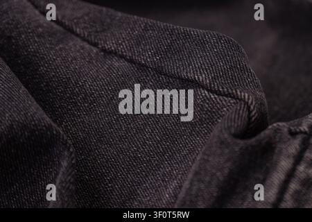 Black jeans close-up, intricate weave, subtle shade variations, three-dimensional quality, clean professional style, commercial stock photography, tex Stock Photo