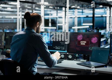 Server room computer scientist trying to fix system faults working with AI program. Stock Photo