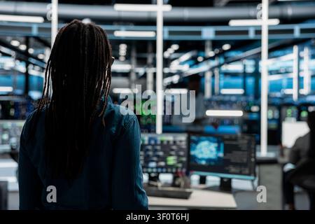 System administrator entering server room office, preparing to operate AI computerized model. Stock Photo