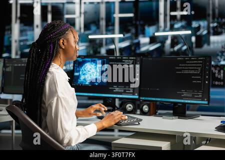 Server room admin running simulations for neural network prediction, tracking performance. Stock Photo