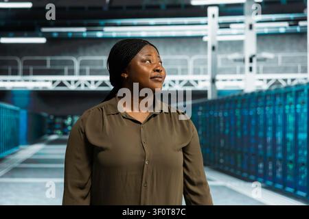 Technical specialist working in computing facility with server hardware layout supporting business technology needs with doing checkup. Stock Photo