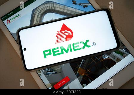 Mexico city, mexico, 06 04 2026, smartphone showing pemex logo over a tablet displaying industrial imagery Stock Photo