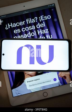 Mexico city, mexico, 06 04 2026, nubank logo displaying on a smartphone, with a tablet showing the registration page in mexico Stock Photo