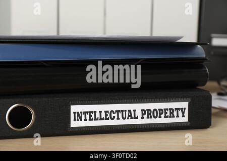 Intellectual Property label on folder on wooden table, closeup Stock Photo