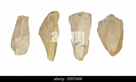Set of prehistoric flint stone tools isolated on white background, four ancient chipped rock artifacts and hand axe blades, archaeology museum, Stone Stock Photo