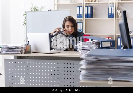 Beautiful female employee unhappy with excessive work Stock Photo