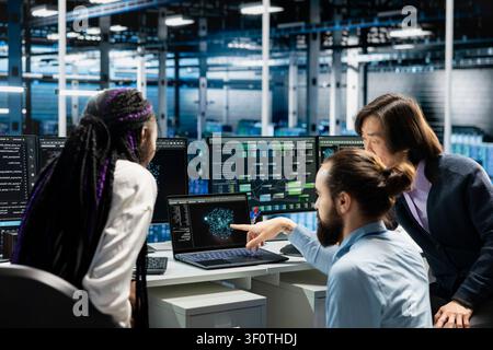 Data center IT coworkers doing planning solutions, launching AI tools to automate repetitive workflows. Stock Photo