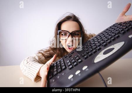 Funny nerd girl working on computer Stock Photo