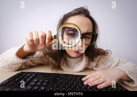 Funny nerd girl working on computer Stock Photo