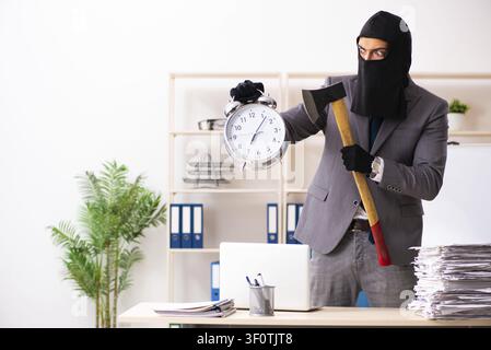 Male gangster stealing information from the office Stock Photo