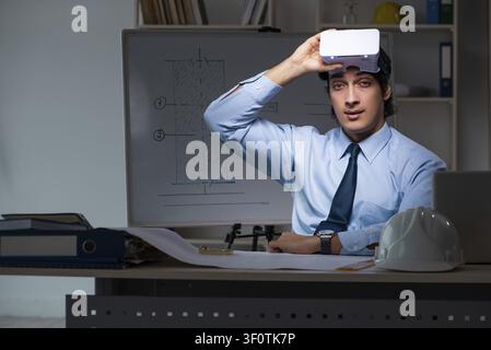 Young male architect working night at office Stock Photo