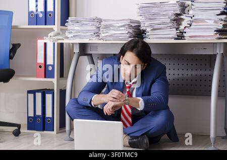 Young businessman employee unhappy with excessive work Stock Photo