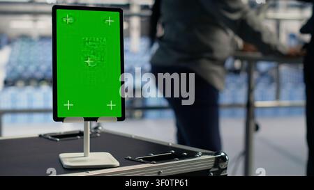 Data center worker works with a chroma key tablet, using an editable screen to manage machine learning workloads. Stock Photo