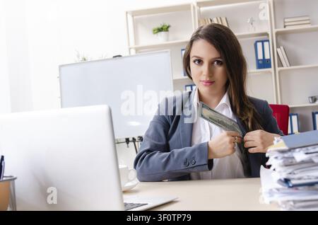 Beautiful female employee unhappy with excessive work Stock Photo