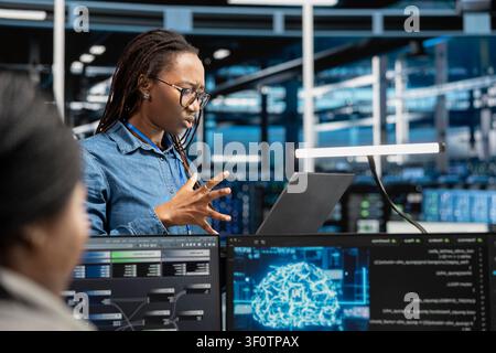 Engineer does monitoring in data center responsible with intense data computations demanding high capacity, scalable, error free network to effectively support AI workloads. Stock Photo
