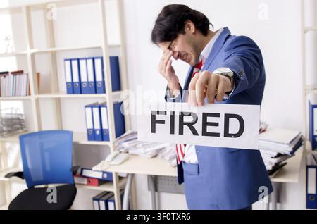 Young businessman employee unhappy with excessive work Stock Photo