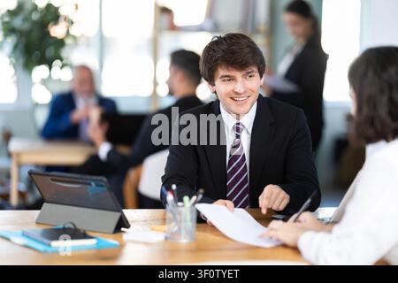 Bank manager talking with female client in office Stock Photo