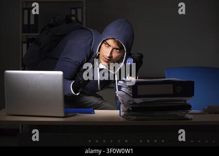 Thief trying to steal personal data in identity theft concept Stock Photo