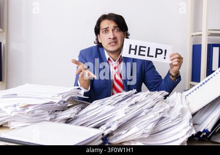 Young businessman employee unhappy with excessive work Stock Photo