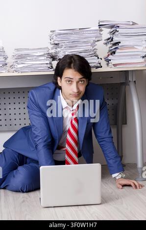 Young businessman employee unhappy with excessive work Stock Photo