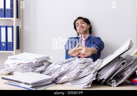 Young businessman employee unhappy with excessive work Stock Photo