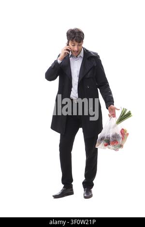 Young handsome man with vegatables in shopping concept Stock Photo