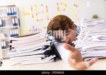 Young employee suffering from excessive work Stock Photo