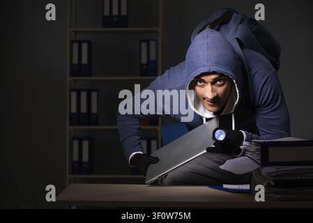 Thief trying to steal personal data in identity theft concept Stock Photo