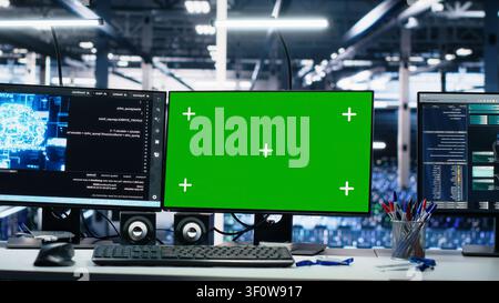 IT specialist reviews neural network visualization on green screen computers in a server room during software debugging work. Stock Photo