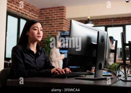 Asian developer programs security algorithm with code with code, databases and network security work focused on data protection, firewalls and software development Stock Photo