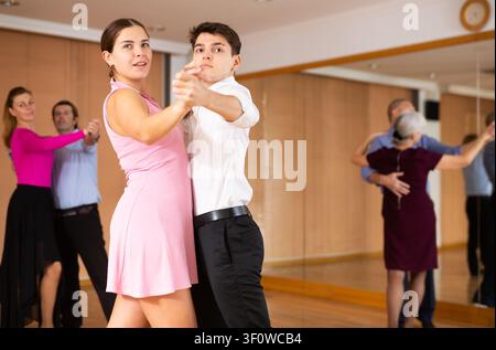 Young pair practicing ballroom dance in dance studio Stock Photo
