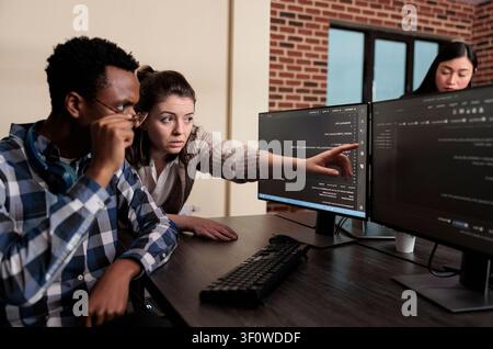 Software developer warning about security data breach Tech engineer observing multiple system security breaches caused by overloaded storage servers. Stock Photo