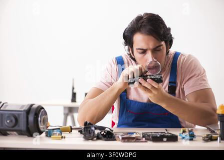 Young male contractor repairing computer Stock Photo