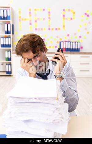 Young employee suffering from excessive work Stock Photo