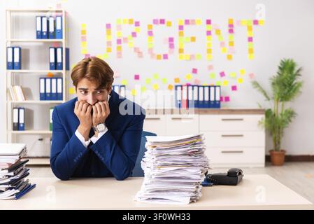 Young employee suffering from excessive work Stock Photo
