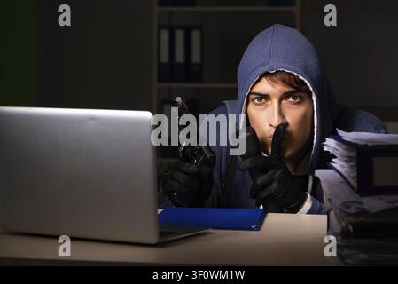 Thief trying to steal personal data in identity theft concept Stock Photo